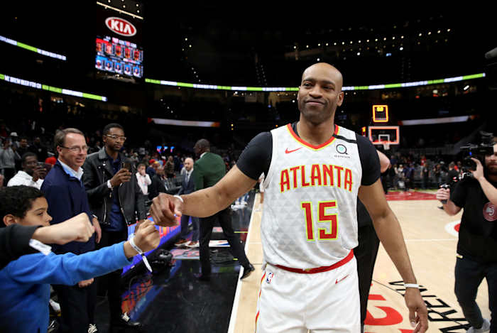 Atlanta Hawks guard Vince Carter (15) fist bumps fans after an overtime loss to the New York Knicks at State Farm Arena.